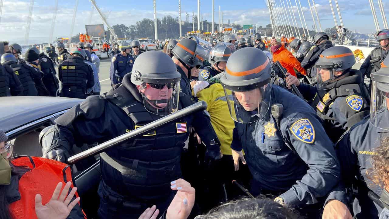 Police clearing protesters from the Bay Bridge, during APEC