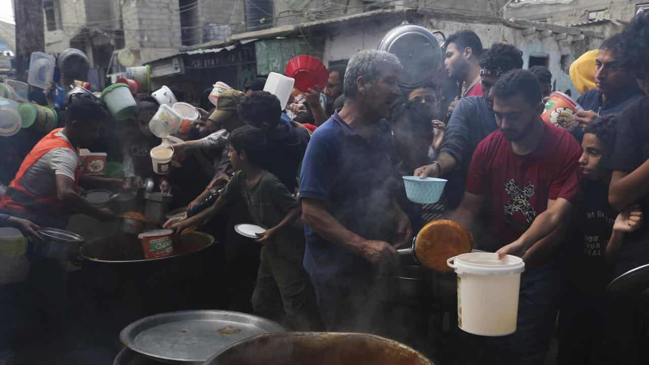 Palestinians line up for food in Rafah, Gaza