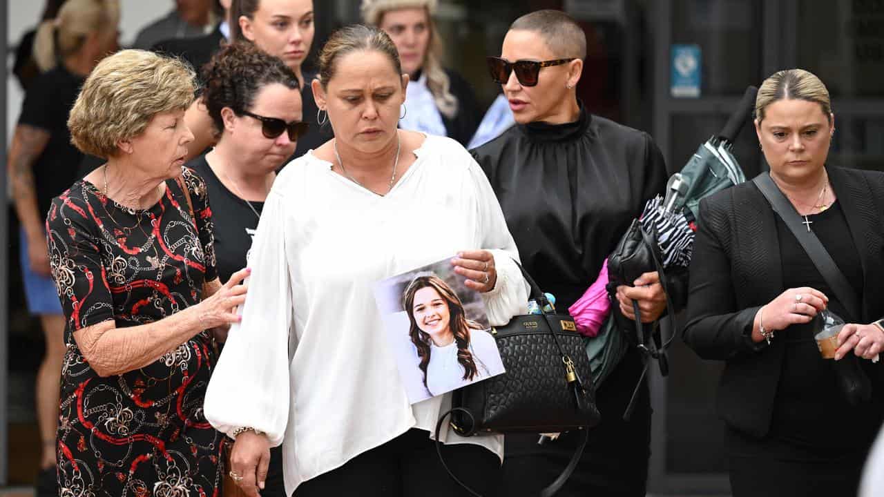 Samantha Trimarchi (wearing white top) carries photo of her daughter