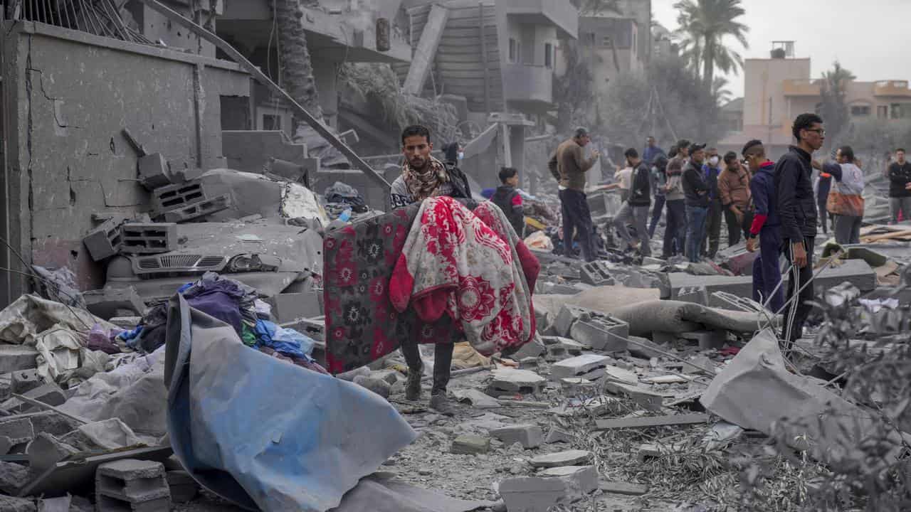 Palestinians after Israeli strikes in Deir al Balah