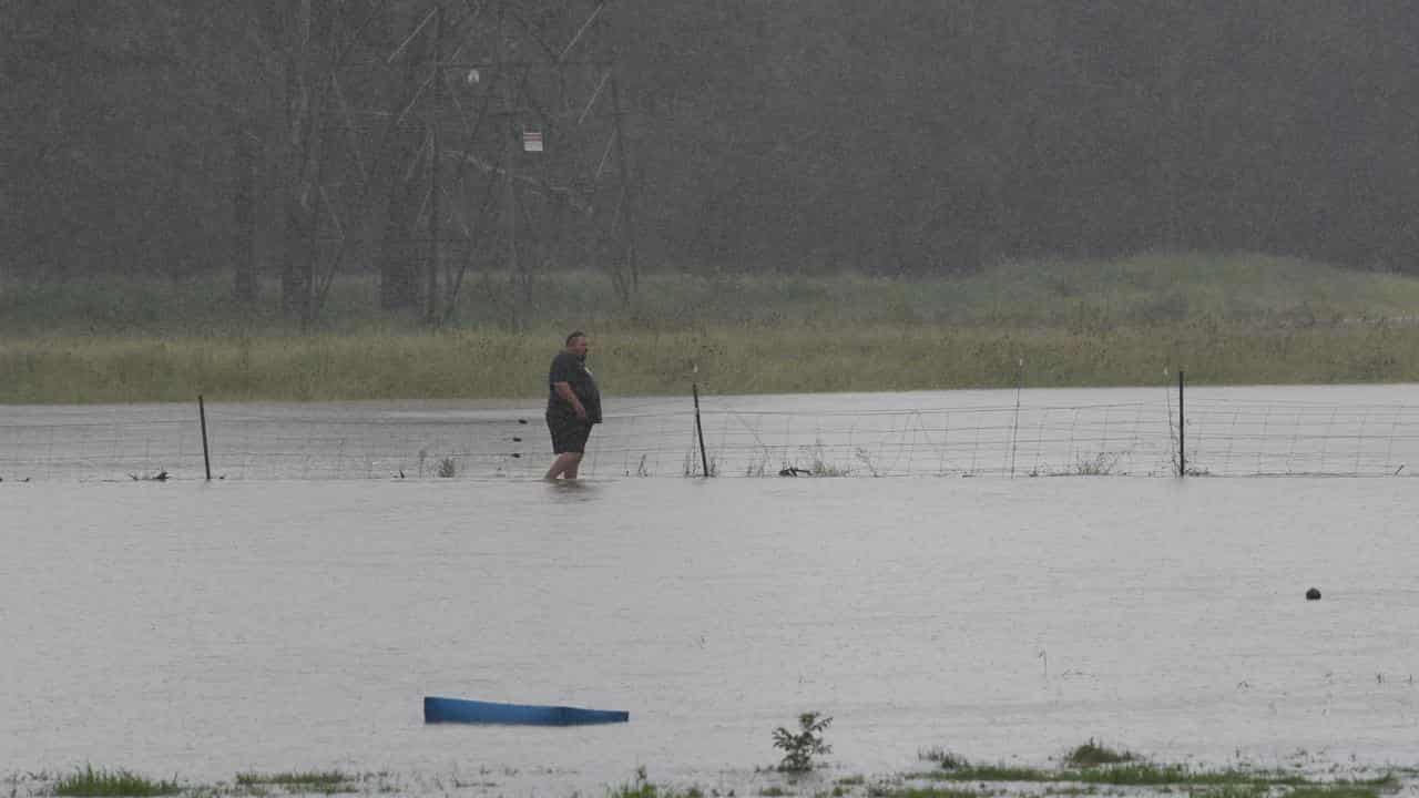 Farmers on Grange Road in Schofield tend to the stock