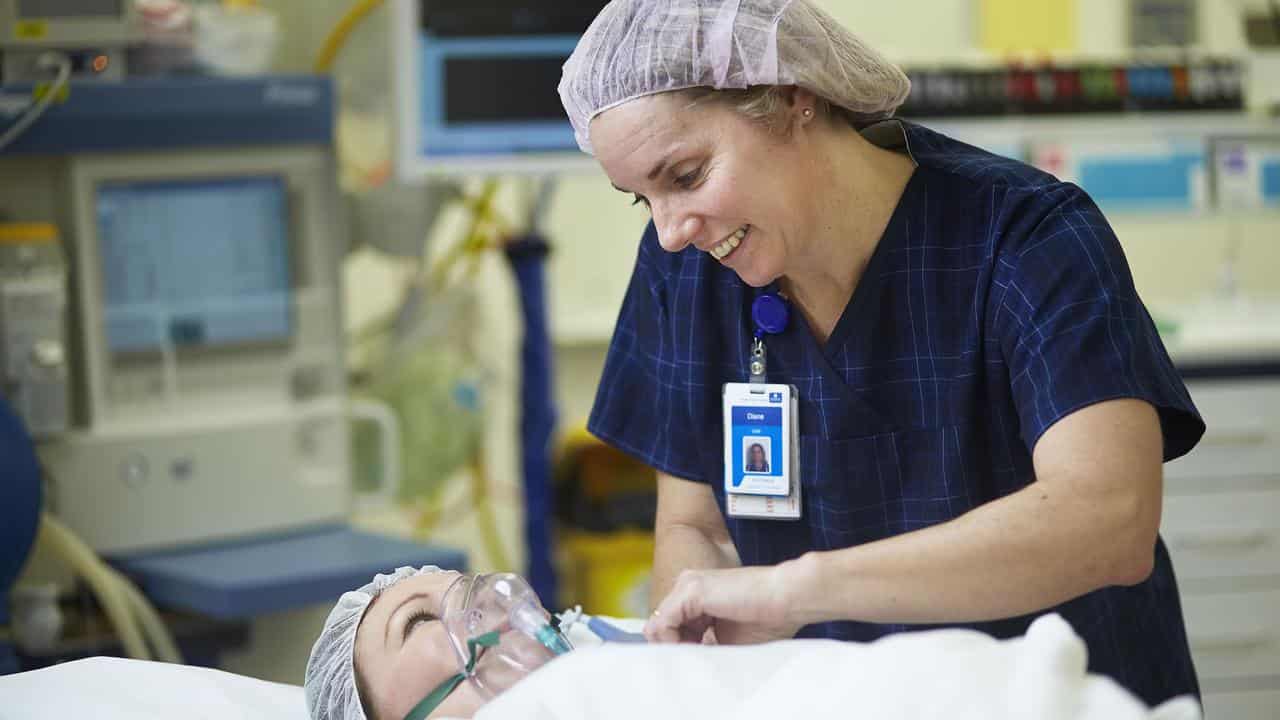 A nurse tends to a patient