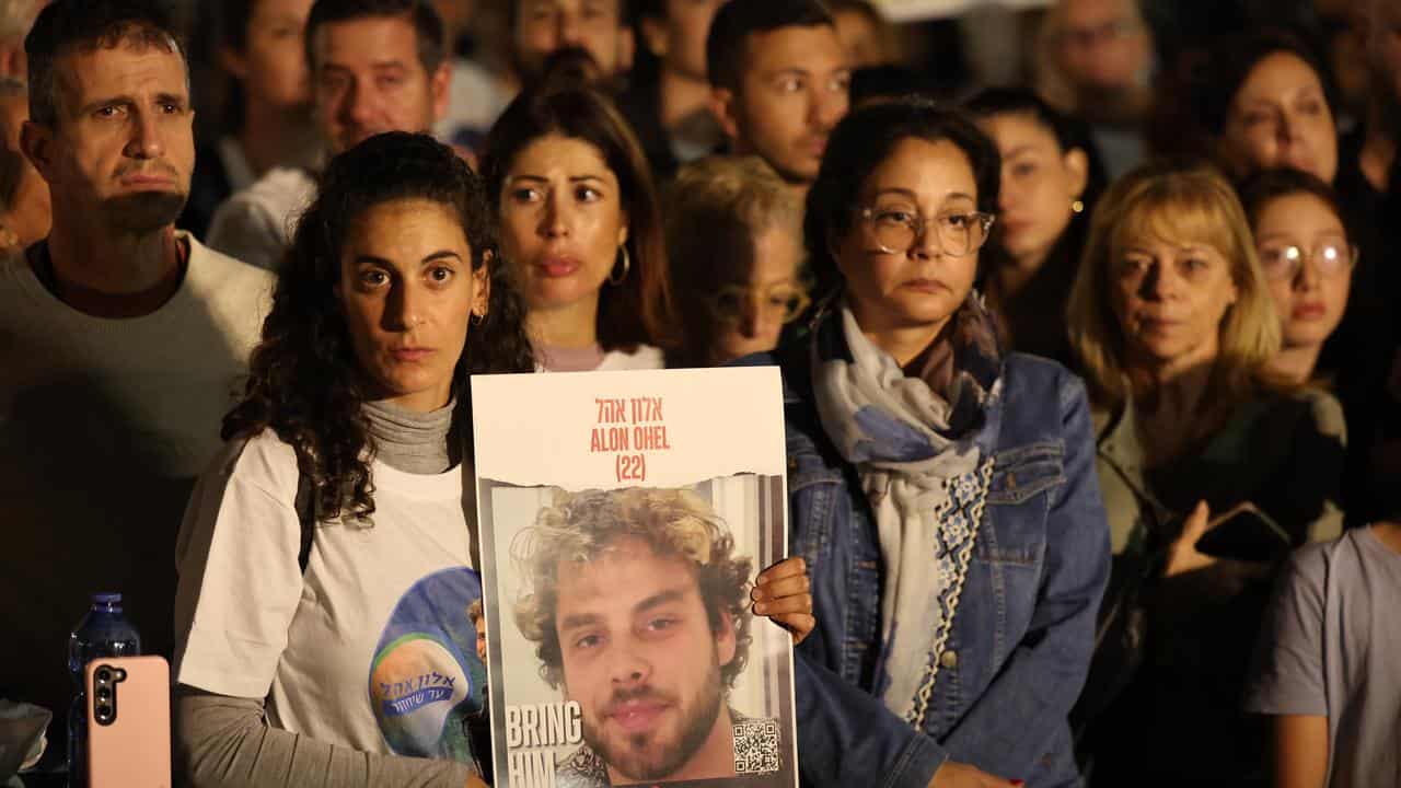 A woman in Tel Aviv with a photo of a man abducted by Hamas militants