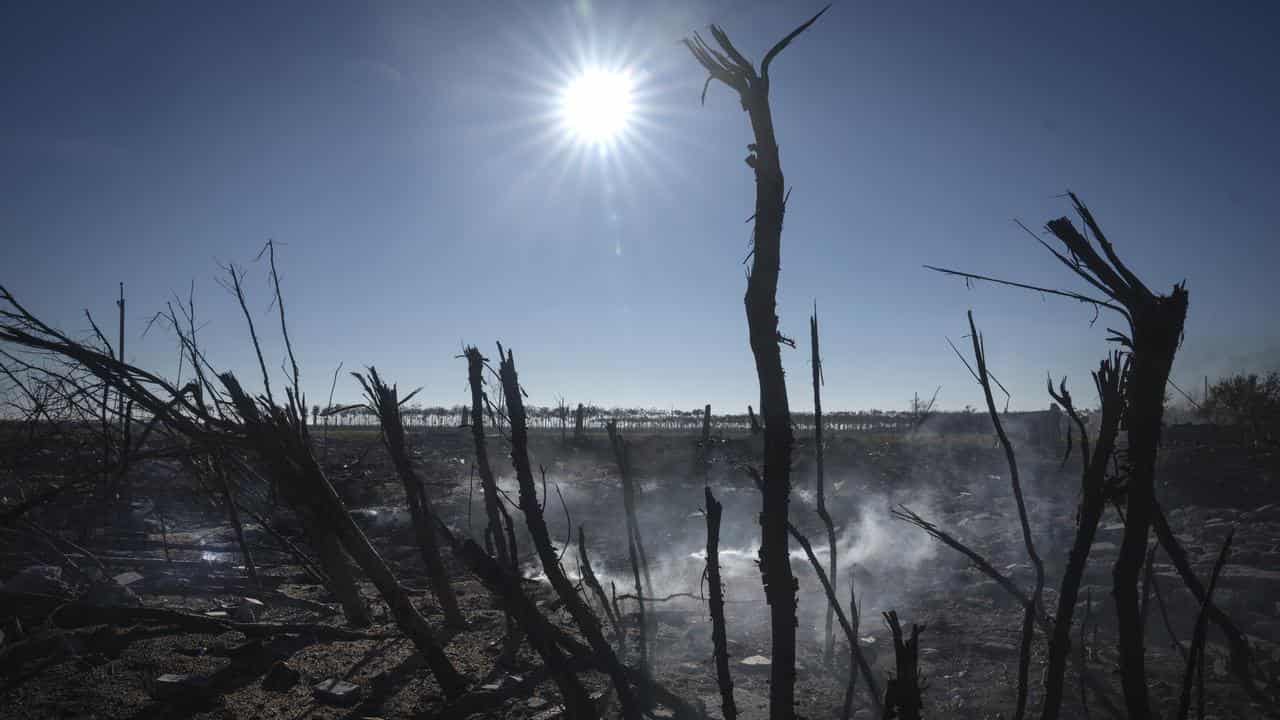 Smoke rises from ruins after Russian attack near Kherson