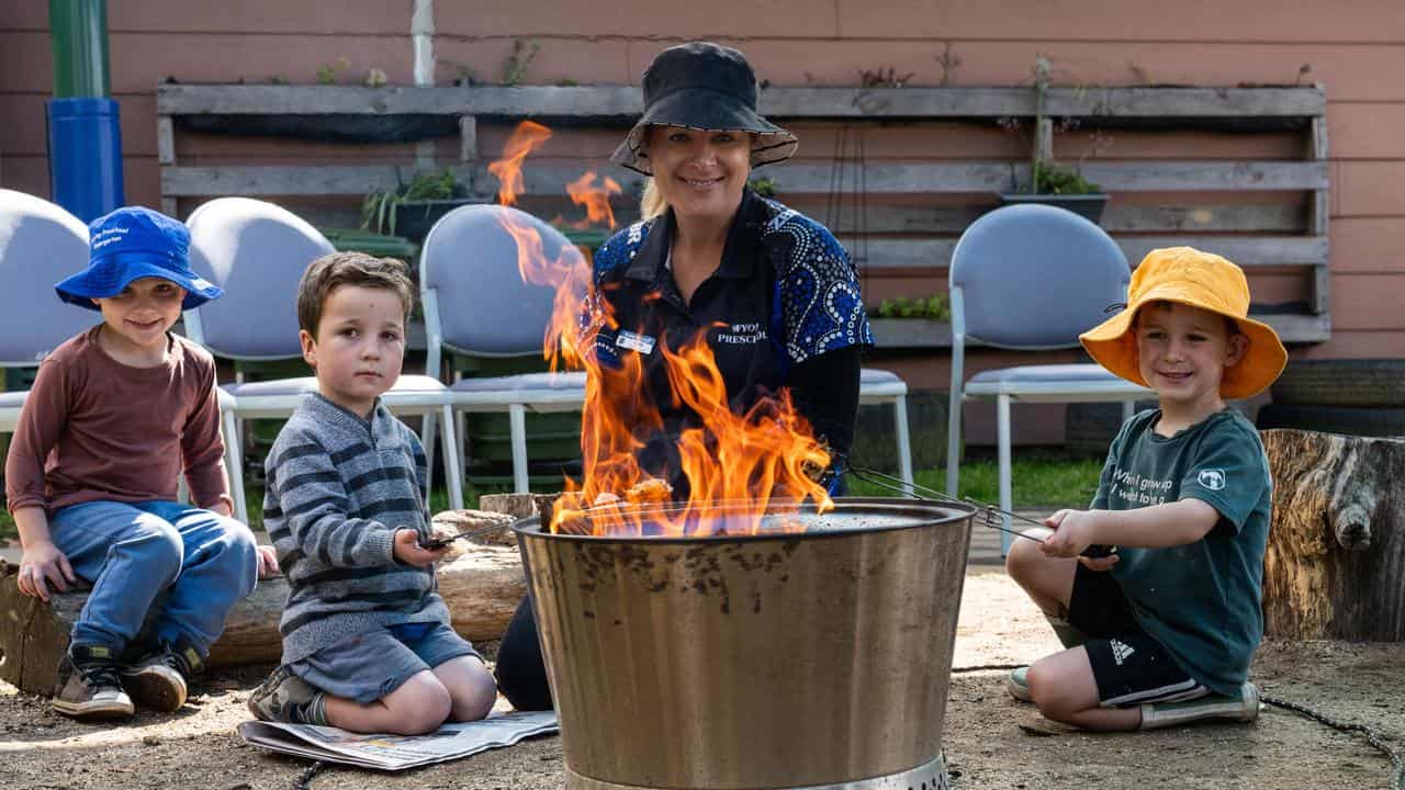 A staff member and children at Wyong Preschool Kindergarten in NSW.