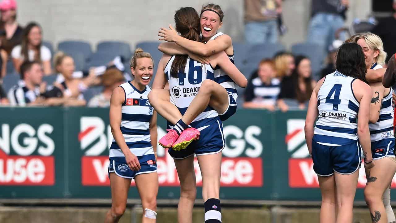 Geelong players celebrate.