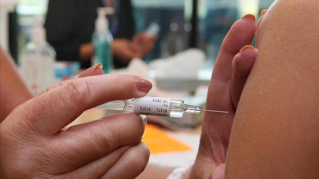 Health care workers receive the flu vaccination injection