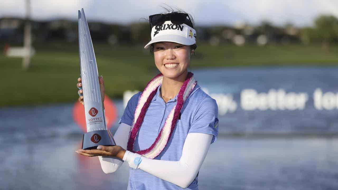 Grace Kim hoists the trophy after winning the Lotte Championship.