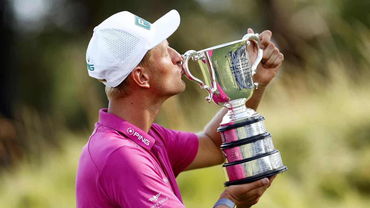 Polish golfer Adrian Meronk with the 2022 Australian Open trophy. 