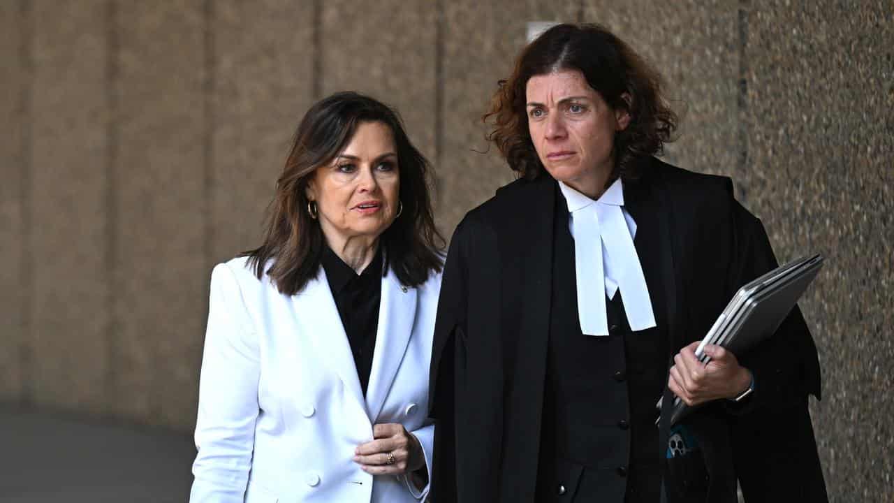 Lisa Wilkinson and her barrister outside Federal Court in Sydney.