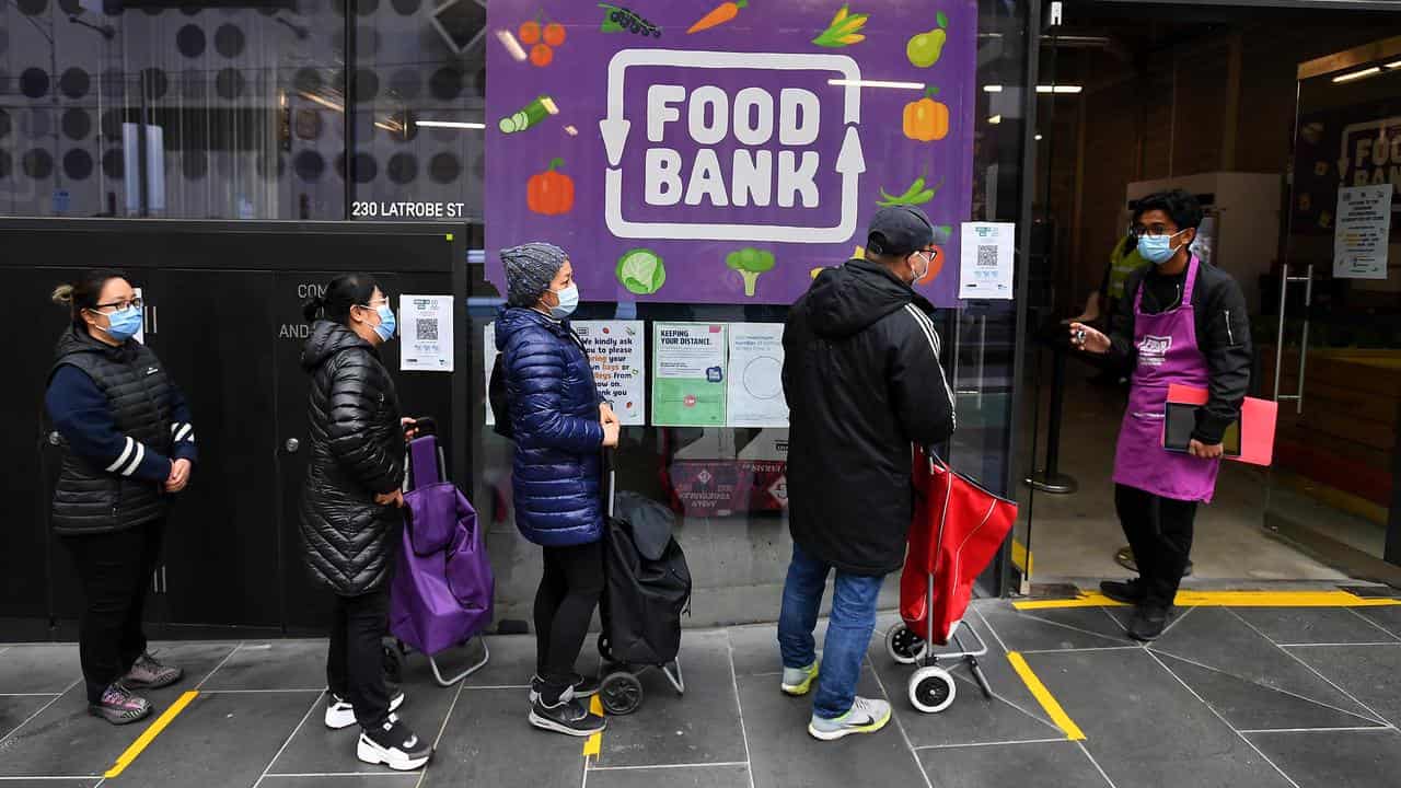 People line up at a Food Bank outlet.