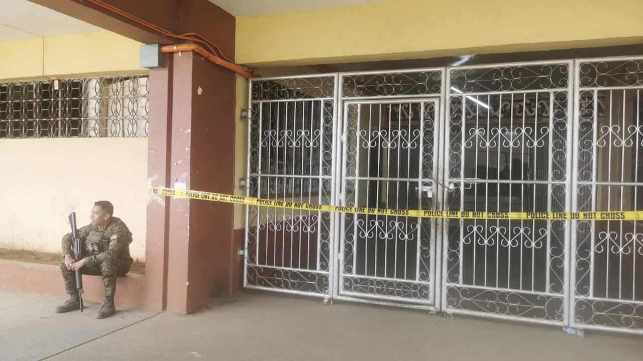 A Filipino trooper guards the site where a bomb exploded