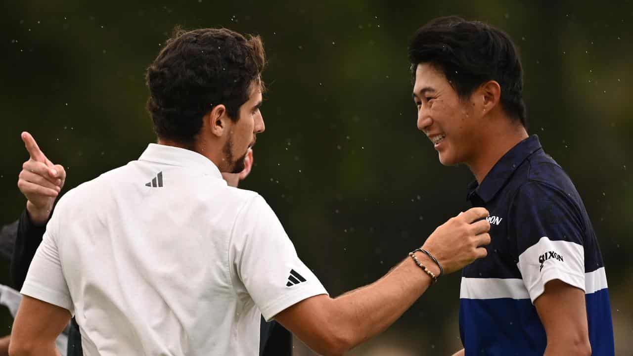 Joaquin Niemann (L) is congratulated by Rikuya Hoshino.