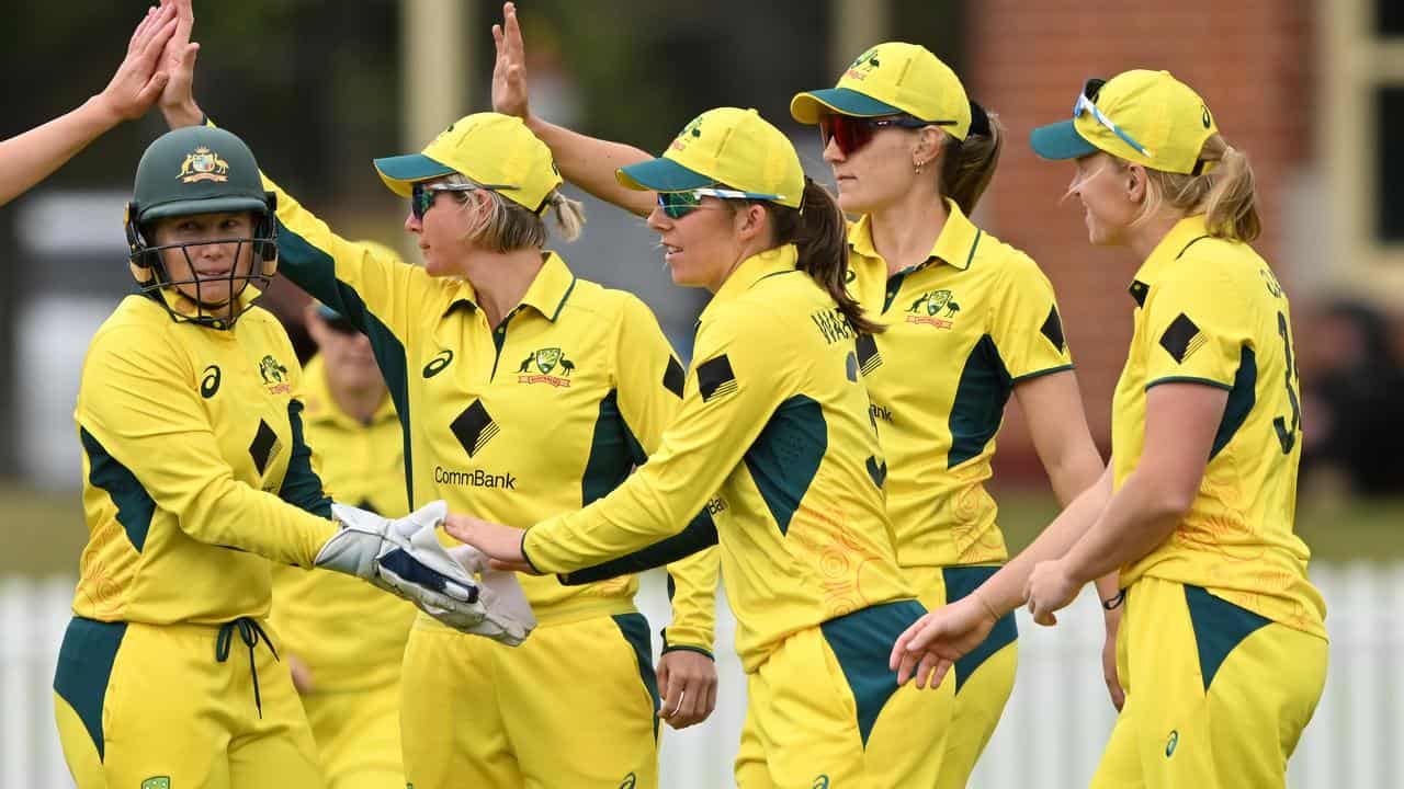 Australia's women cricketers celebrate a West Indies wicket.