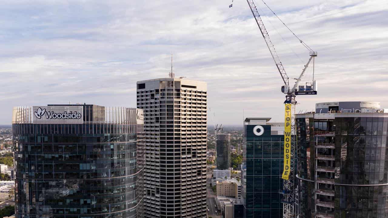 A Greenpeace banner on a crane next to the Woodside's  Perth HQ.