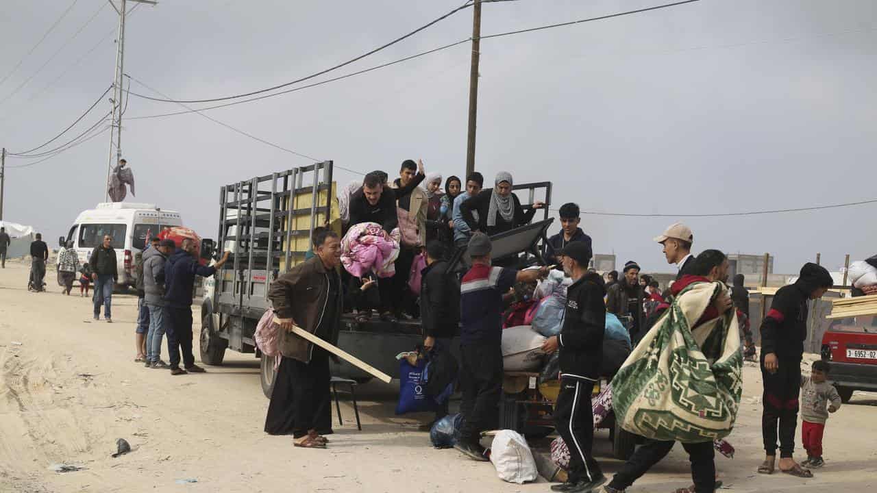 Palestinians fleeing the Israeli ground offensive arrive in Rafah.