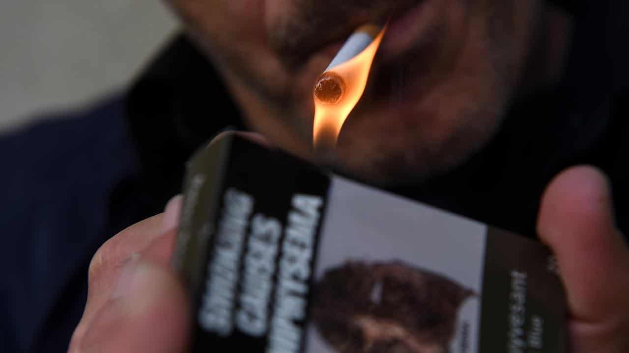 A smoker lights a cigarette (file image)