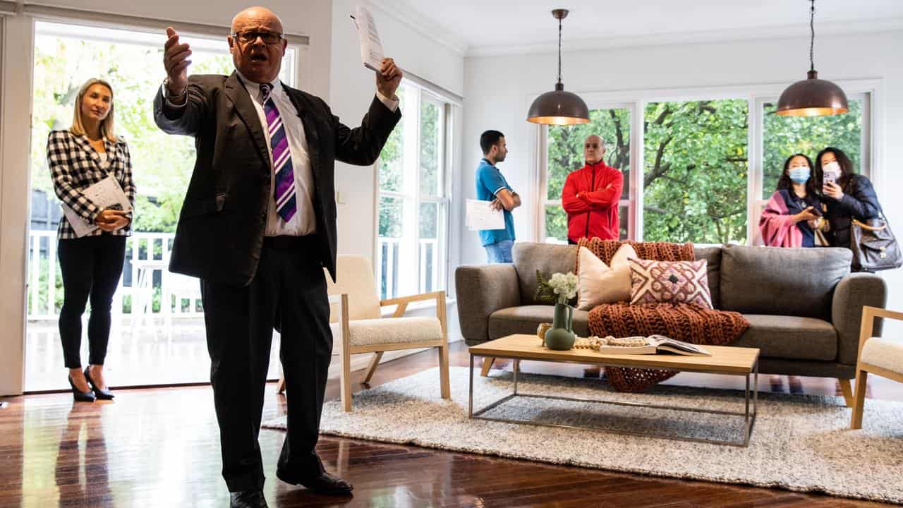 An auction director conducts an auction on a property in Melbourne