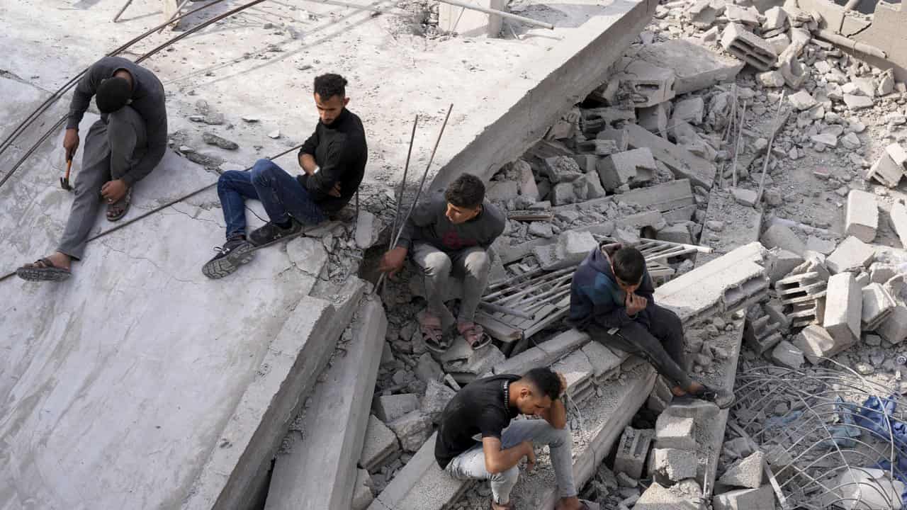 People at a bombed out house