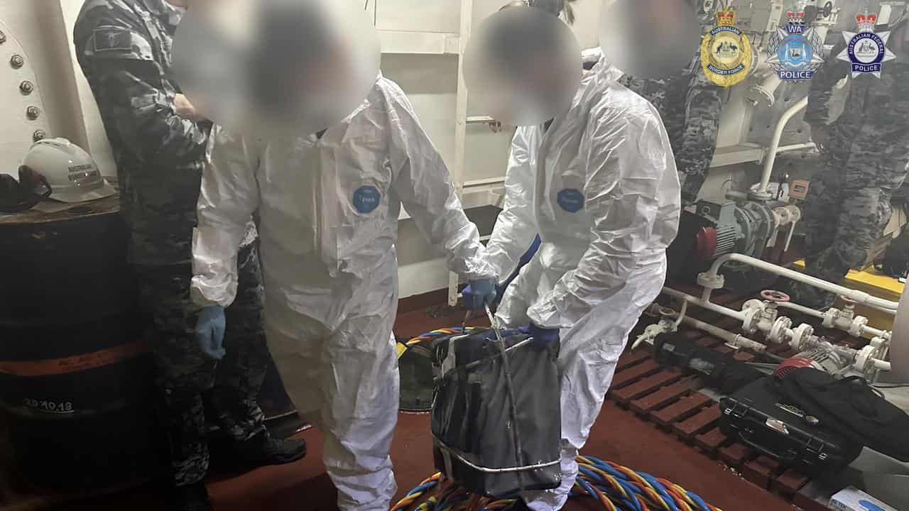 Navy divers retrieve packages allegedly containing cocaine.