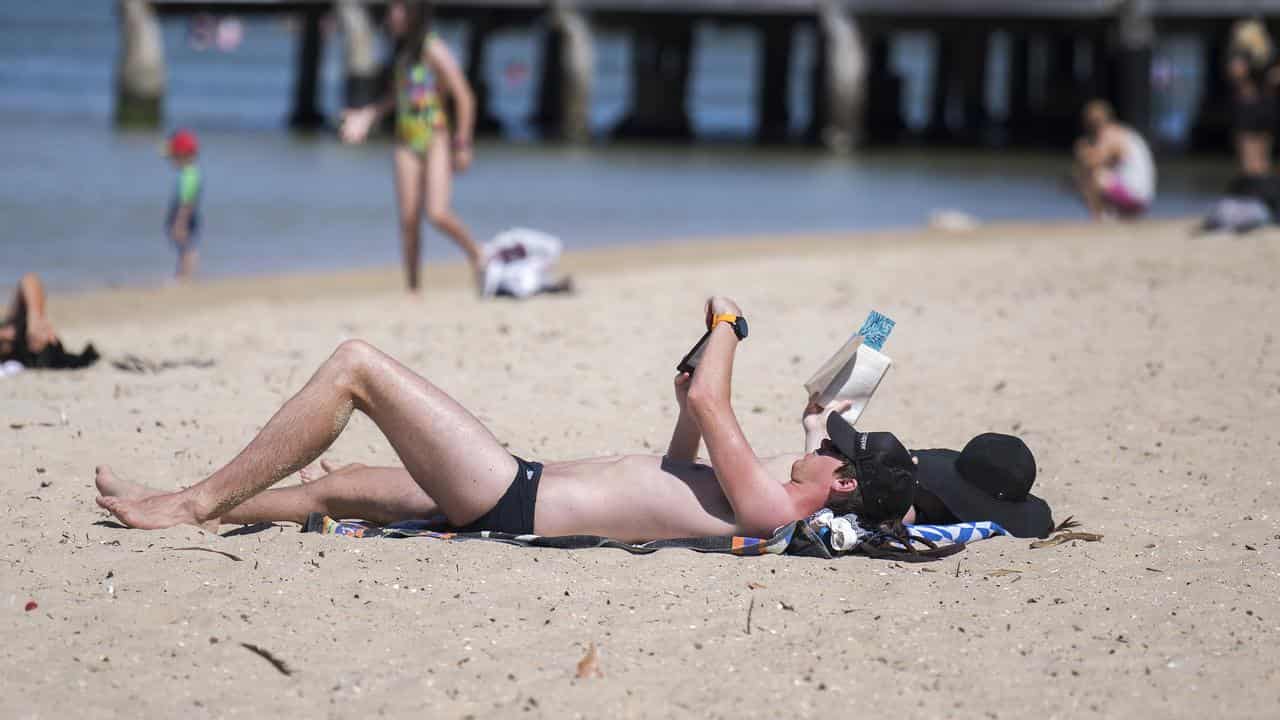 People sunbathing on a beach.