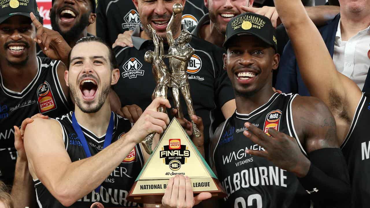 Casey Prather (right) with the 2018 NBL champions trophy.