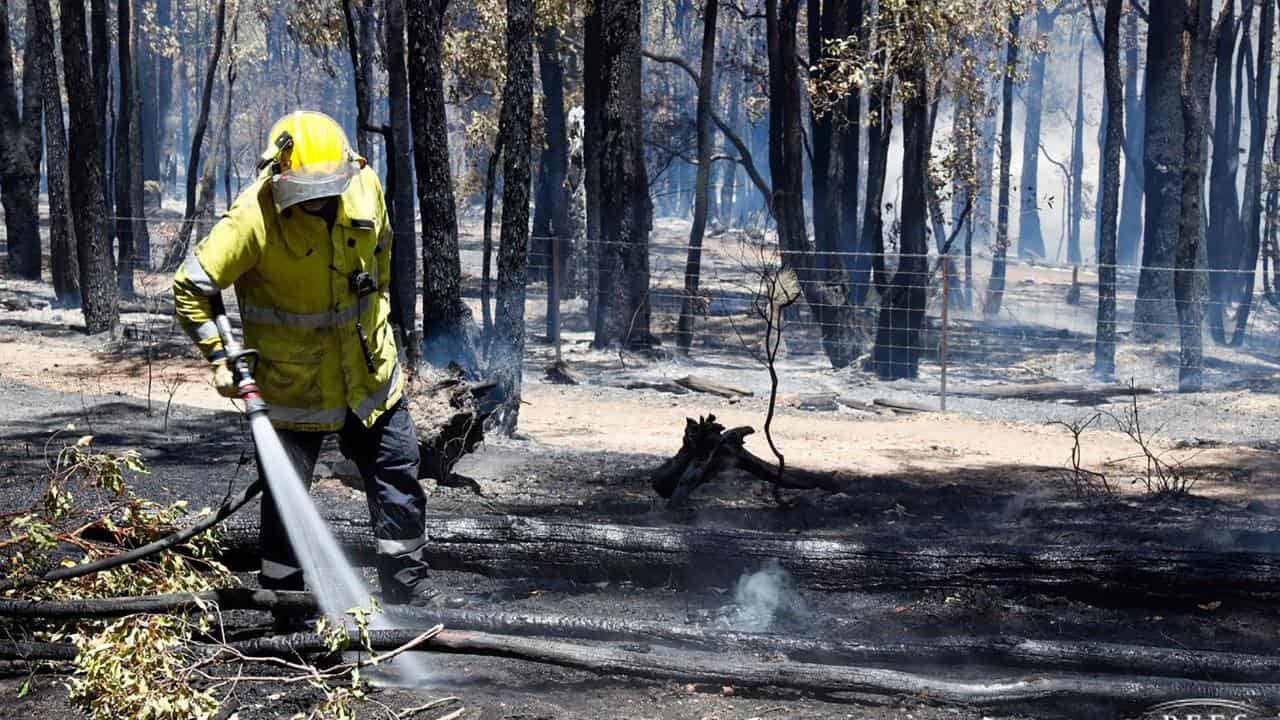 A WA firefighter mops up. 