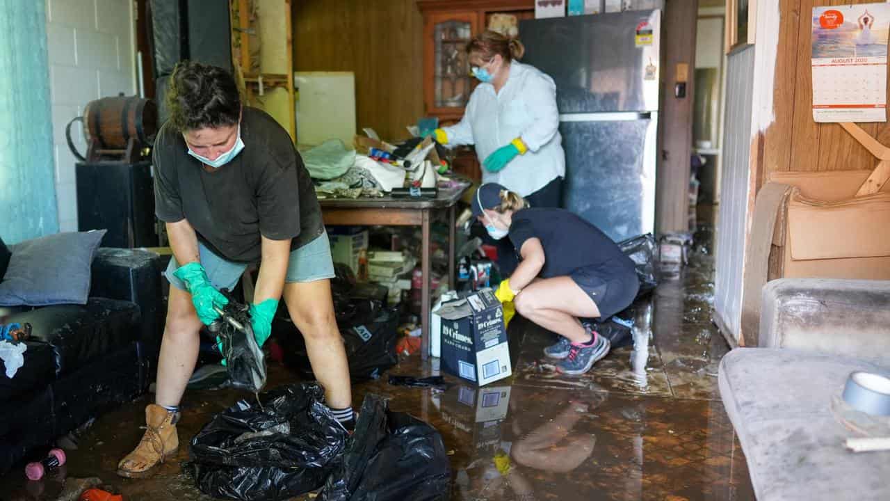 Volunteers help clean up the home of Lynne Flannigan in Cairns.