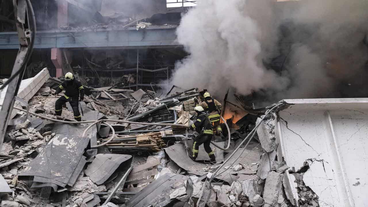 Firefighters working on a bombed out building in Kharkiv, Ukraine