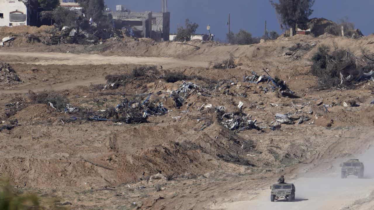 Israeli army vehicles are seen near the Gaza Strip border