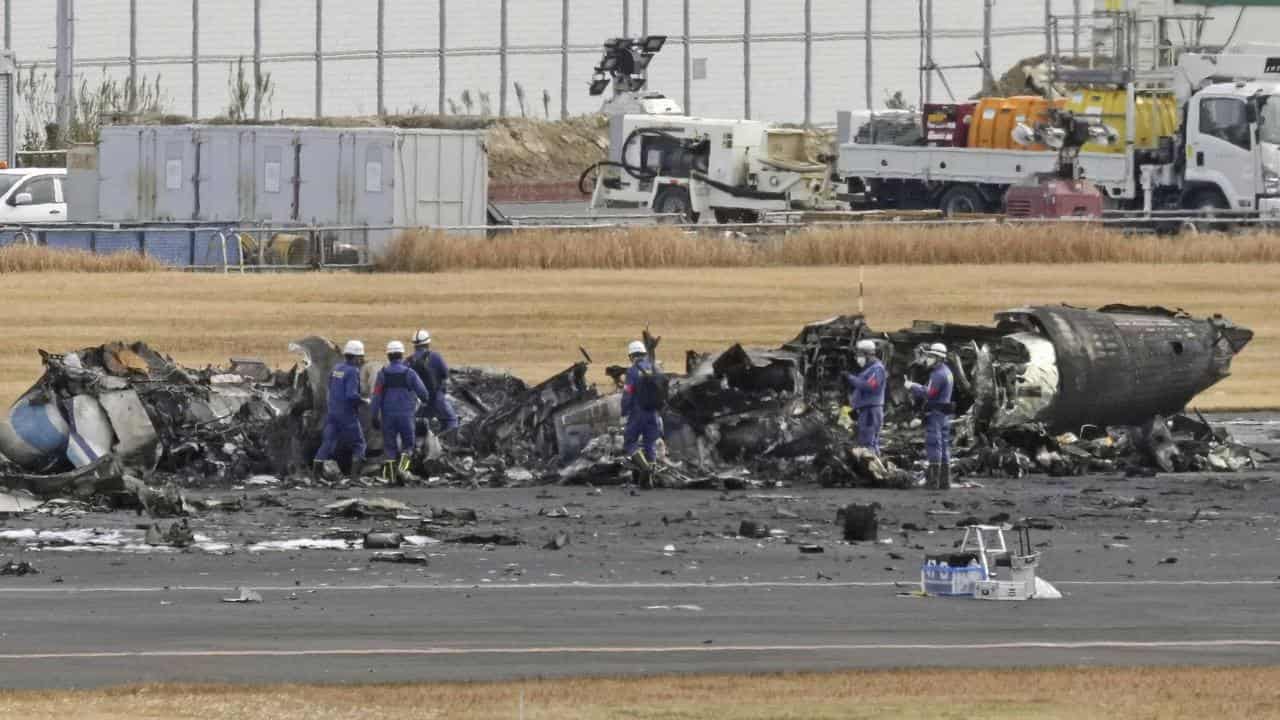 Firefighters at the burnt-out plane 