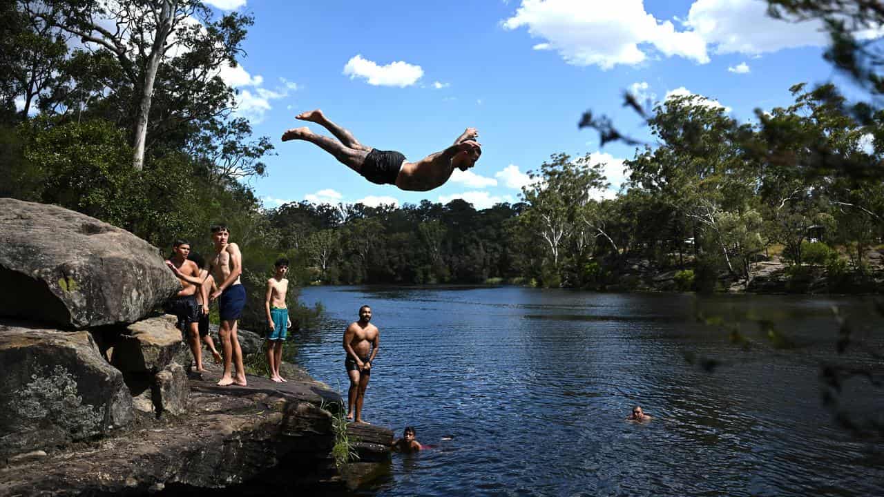 People swimming in a waterhole