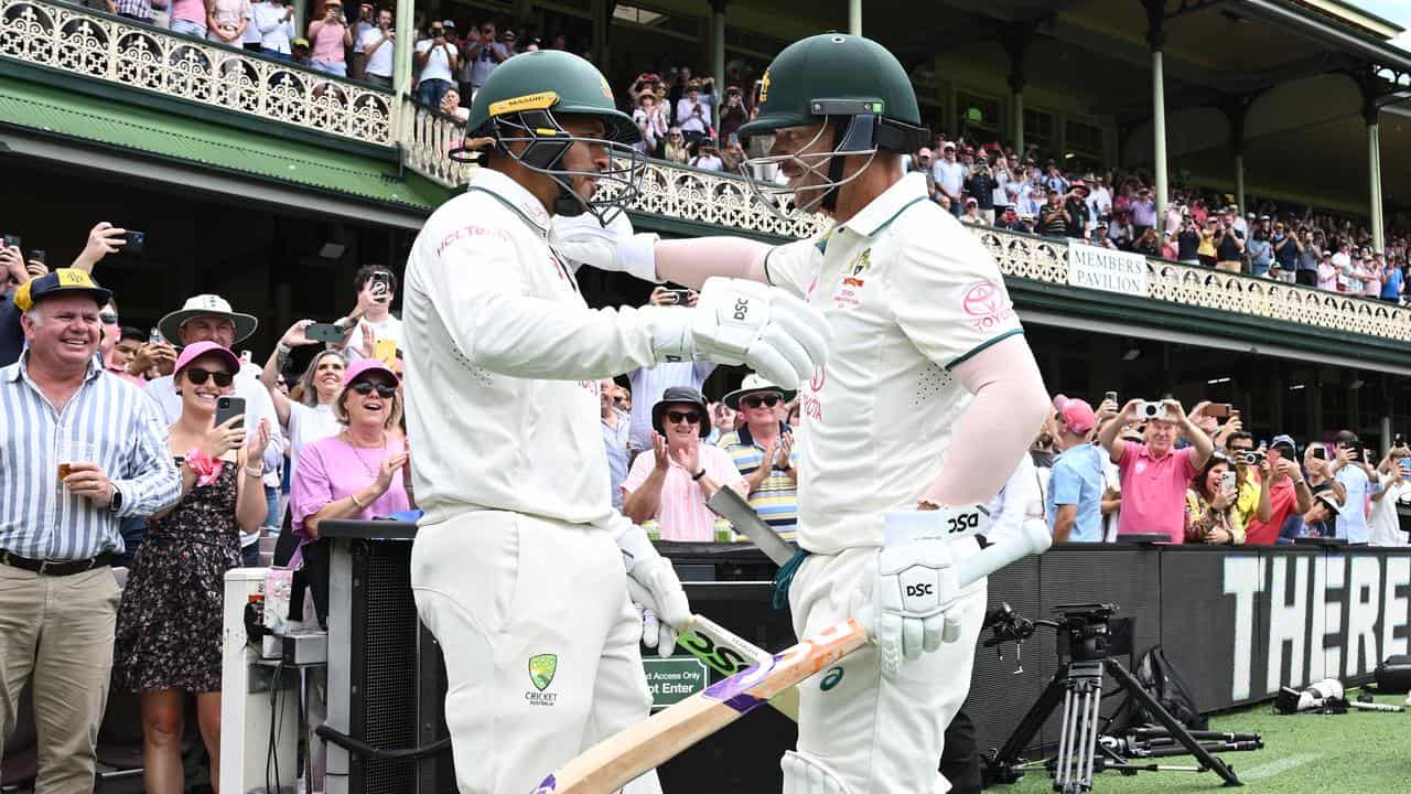 Usman Khawaja (left) and David Warner embrace at the SCG.