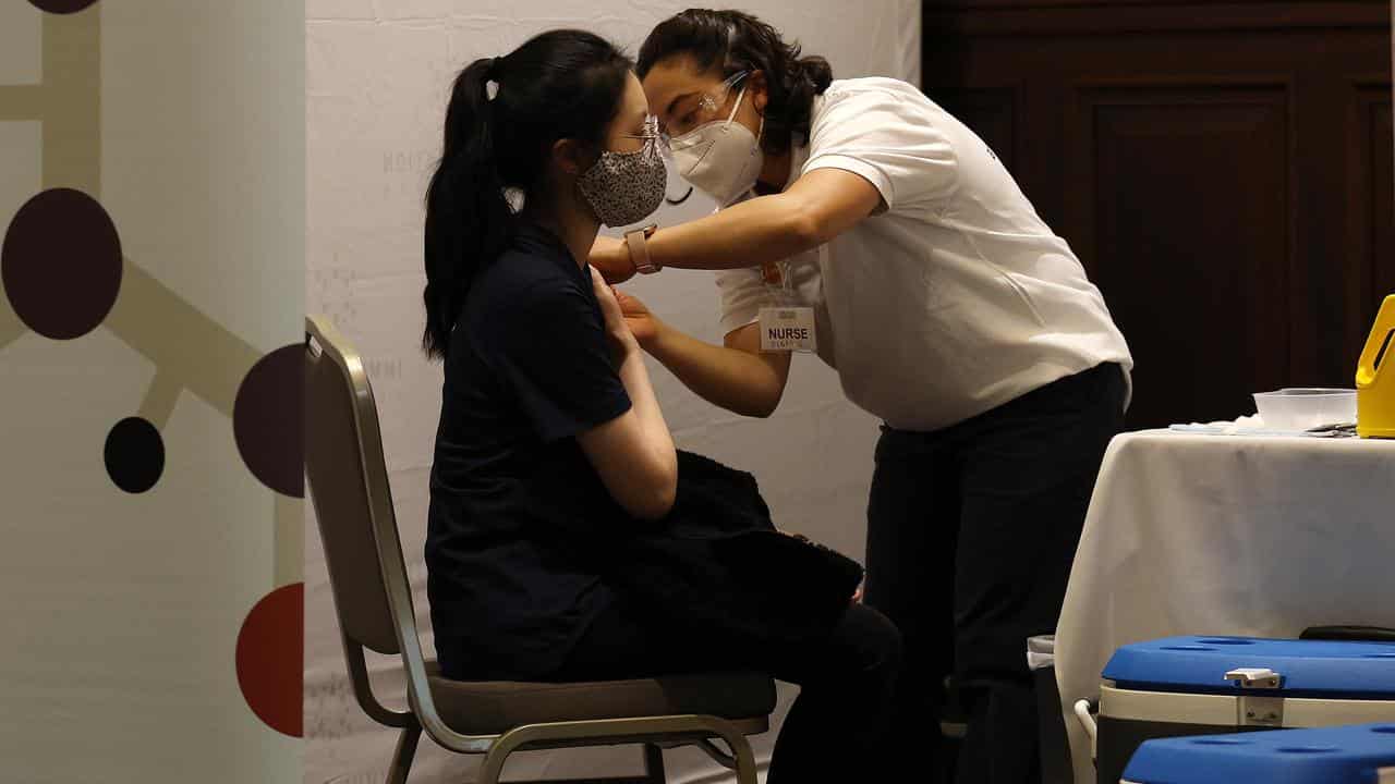 A woman receives a free flu vaccination