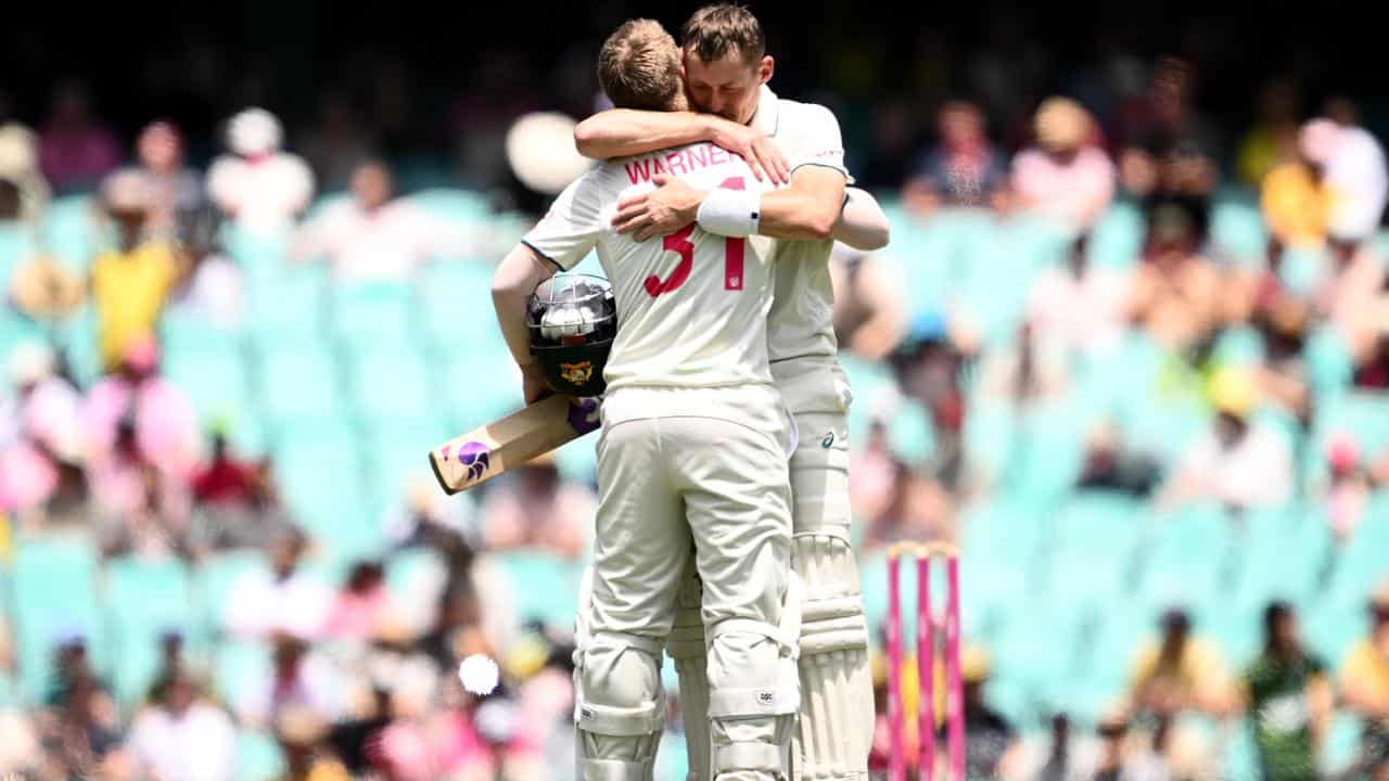 David Warner (left) is embraced by Marnus Labuschagne