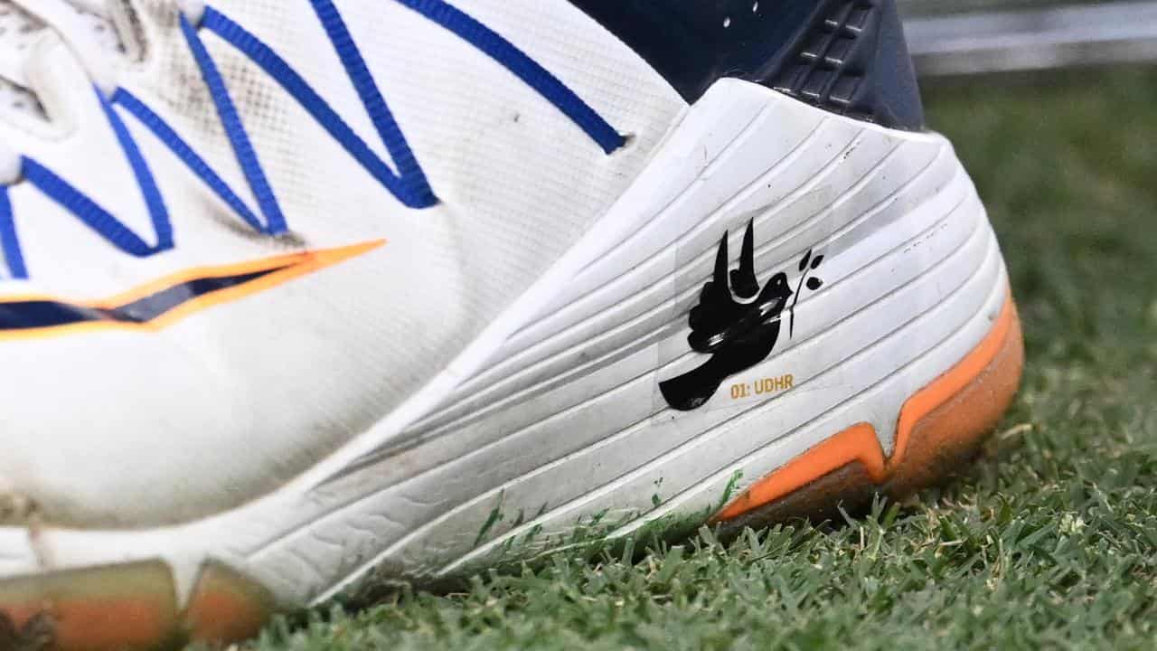 A dove on Usman Khawaja's shoes