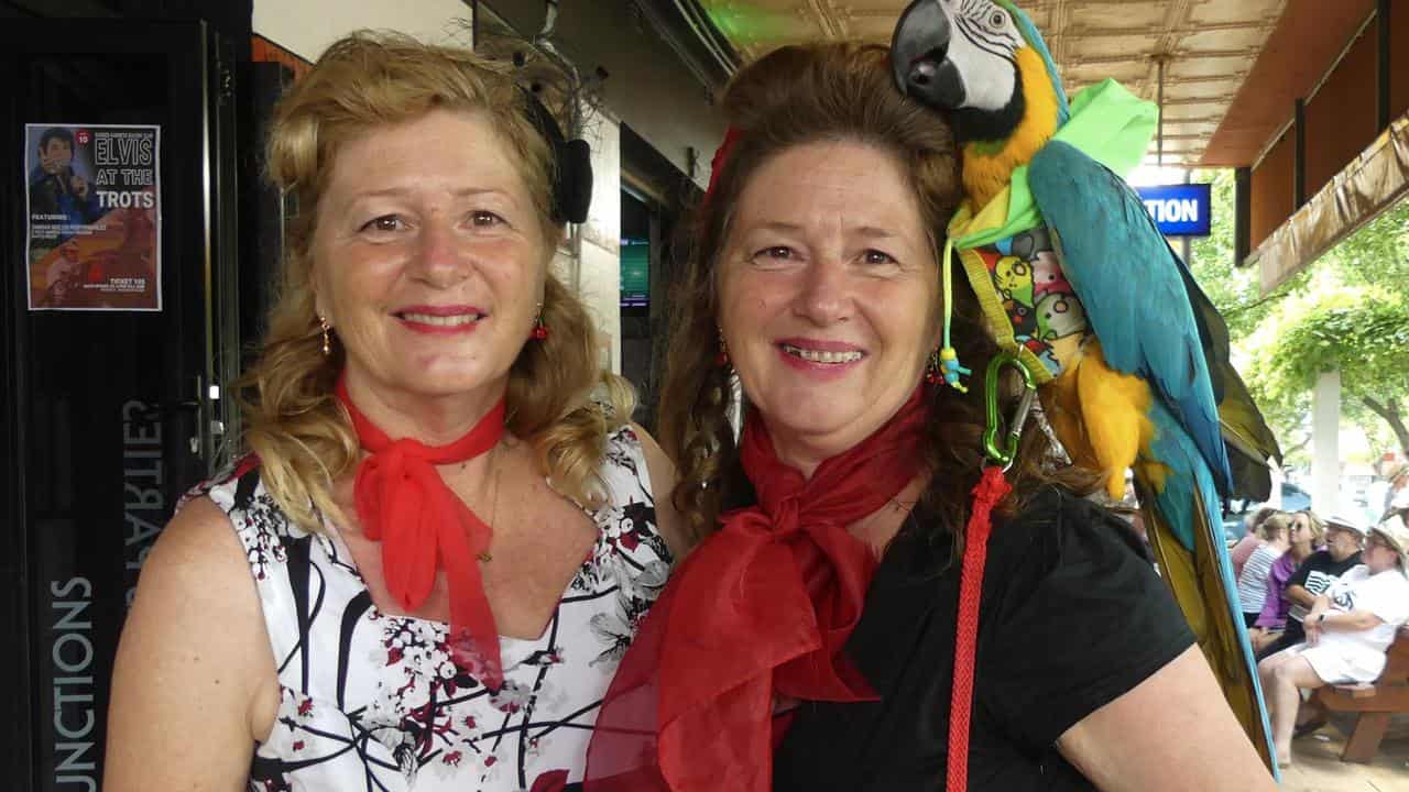 Twins Michelle Green and Susan Gorman with macaw Priscilla