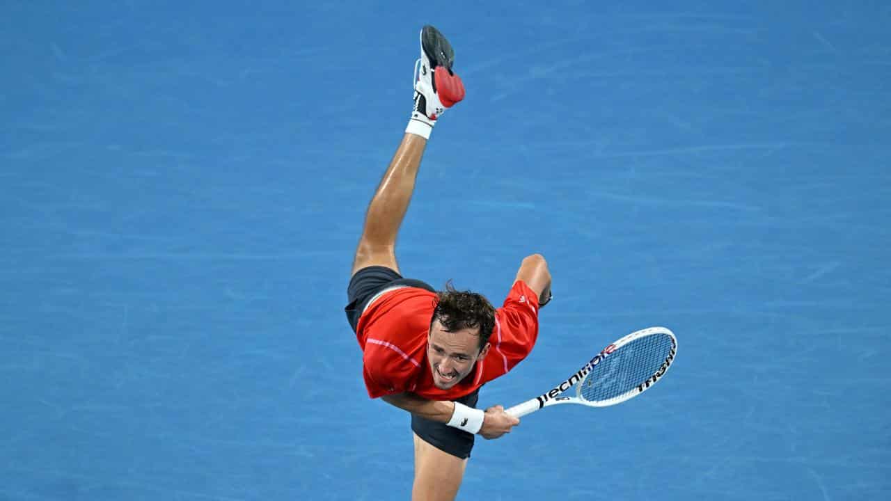 Daniil Medvedev serves against John Millman at 2023's Australian Open.