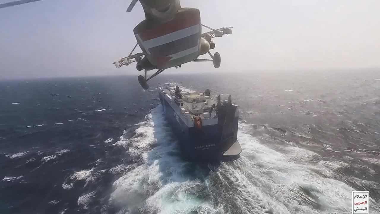 A Houthi forces helicopter approaching a cargo ship