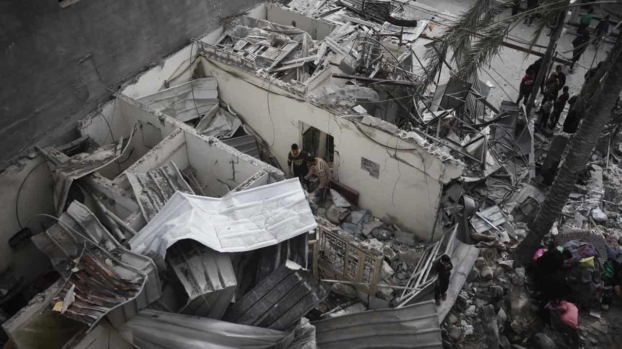 People look at the destruction after an Israeli strike in Kahan Younis