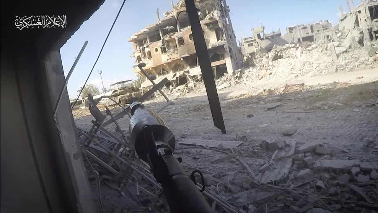 A Hamas fighter aims a rocket at an Israeli tank in Gaza