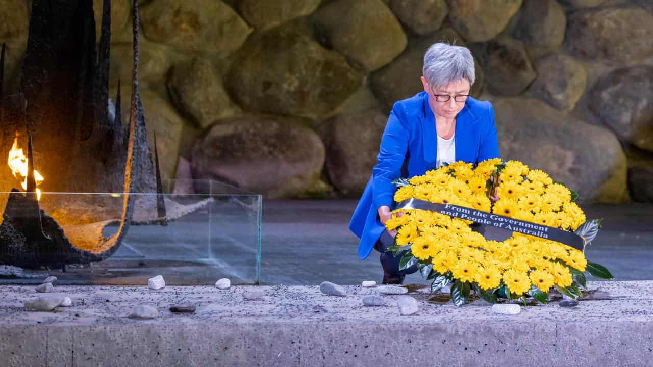 Penny Wong lays a wreath.