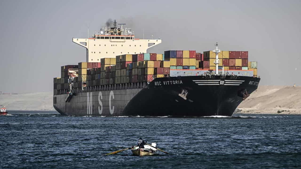 A container ship crosses the Suez Canal towards the Red Sea.