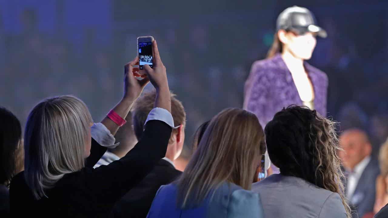 Woman takes photo of model at Melbourne Fashion Festival.