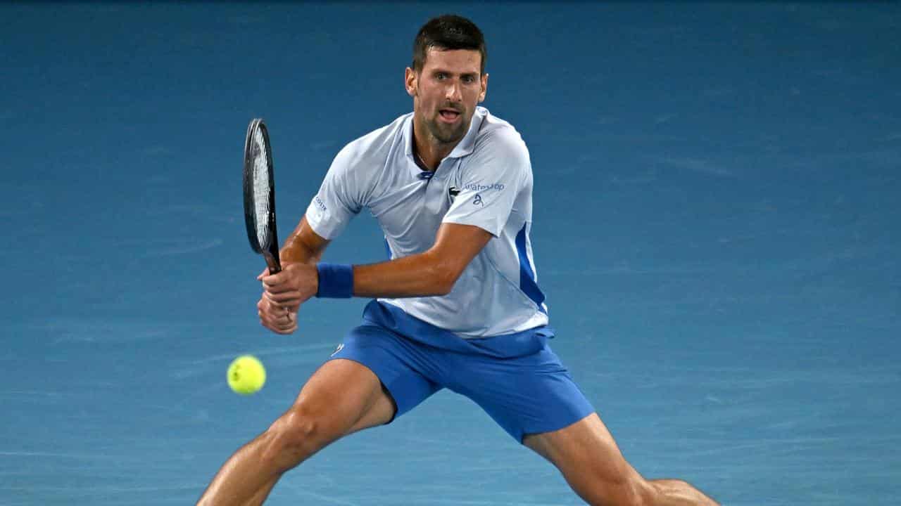 Novak Djokovic hits a backhand.