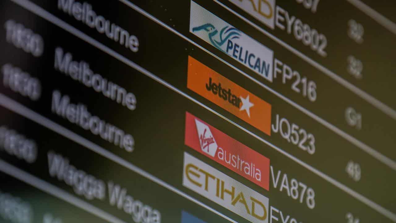 An airport display screen showing flights