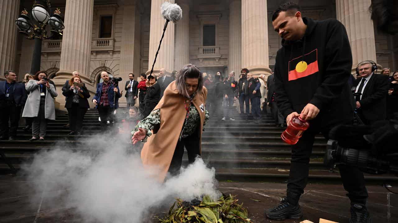 A smoking ceremony on the steps of Victorian Parliament 