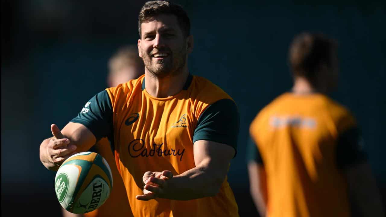 Wallabies player Dave Porecki throws the ball at training.