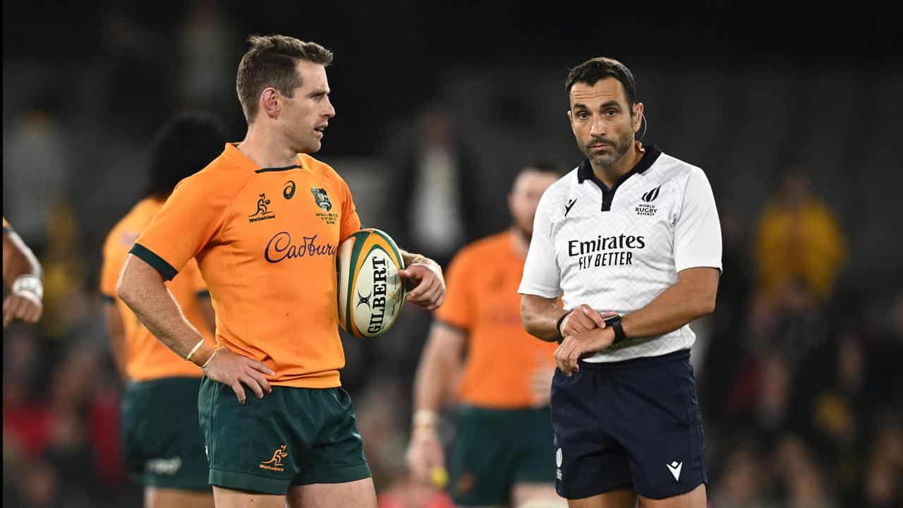 Wallabies player Bernard Foley (left) and referee Mathieu Raynal.