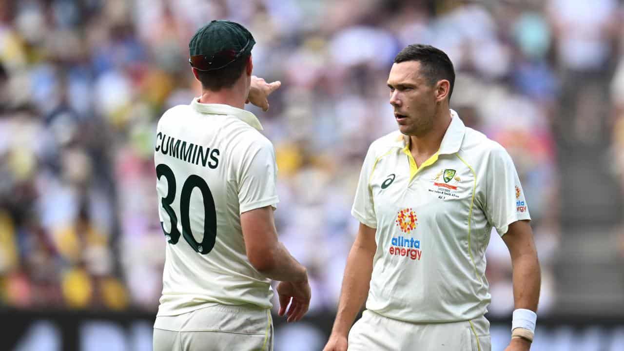 Pat Cummins with bowler Scott Boland (right). 